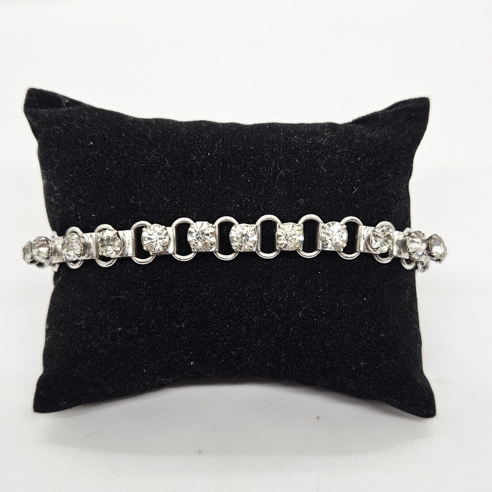 silver tone bracelet with clear prong-set crystals